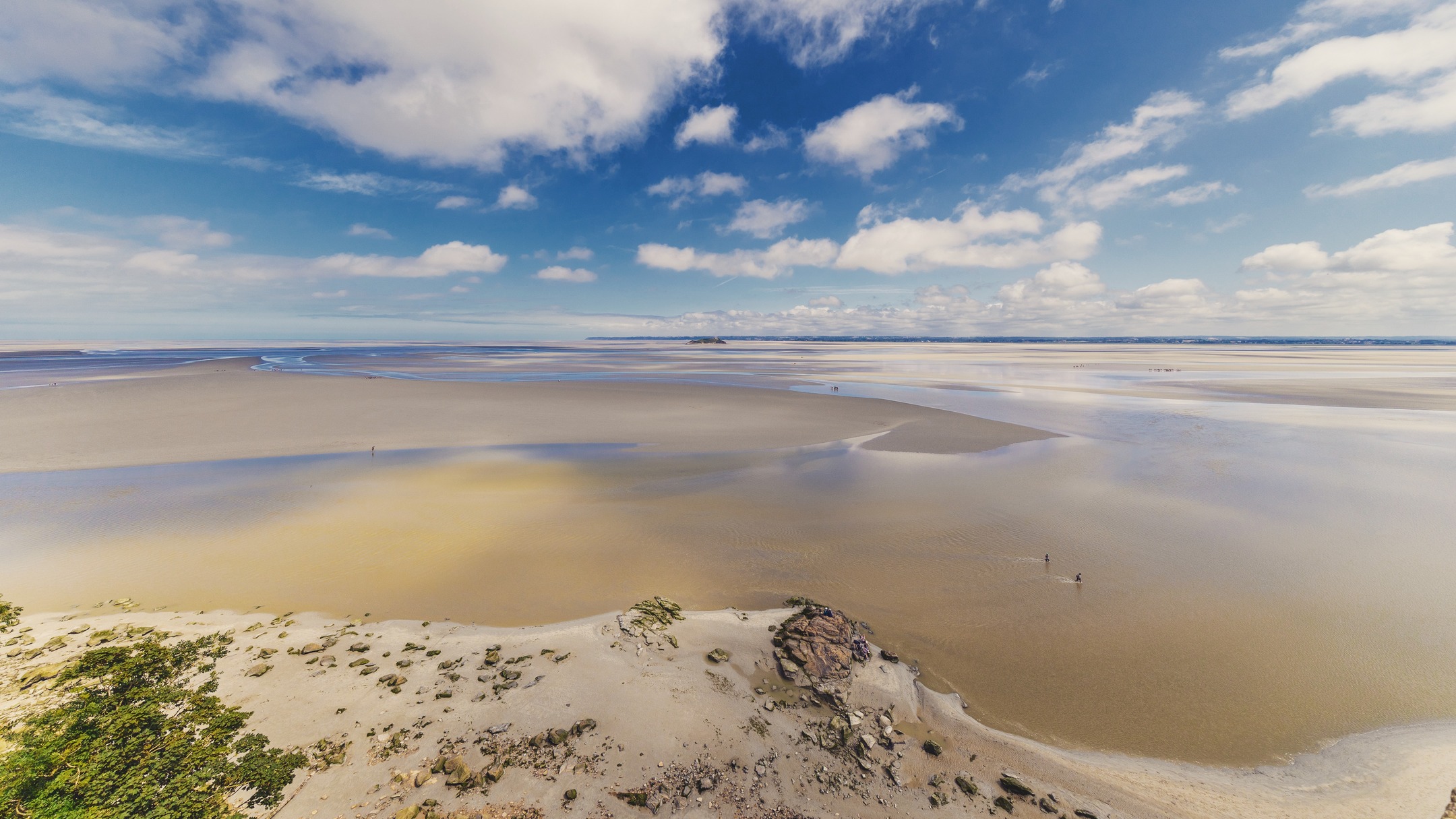 Low tide in the bay from the ramparts at Mont St. Michel with Tombelaine visible in the distance. #tombleaine #montstmichel #normandy #france