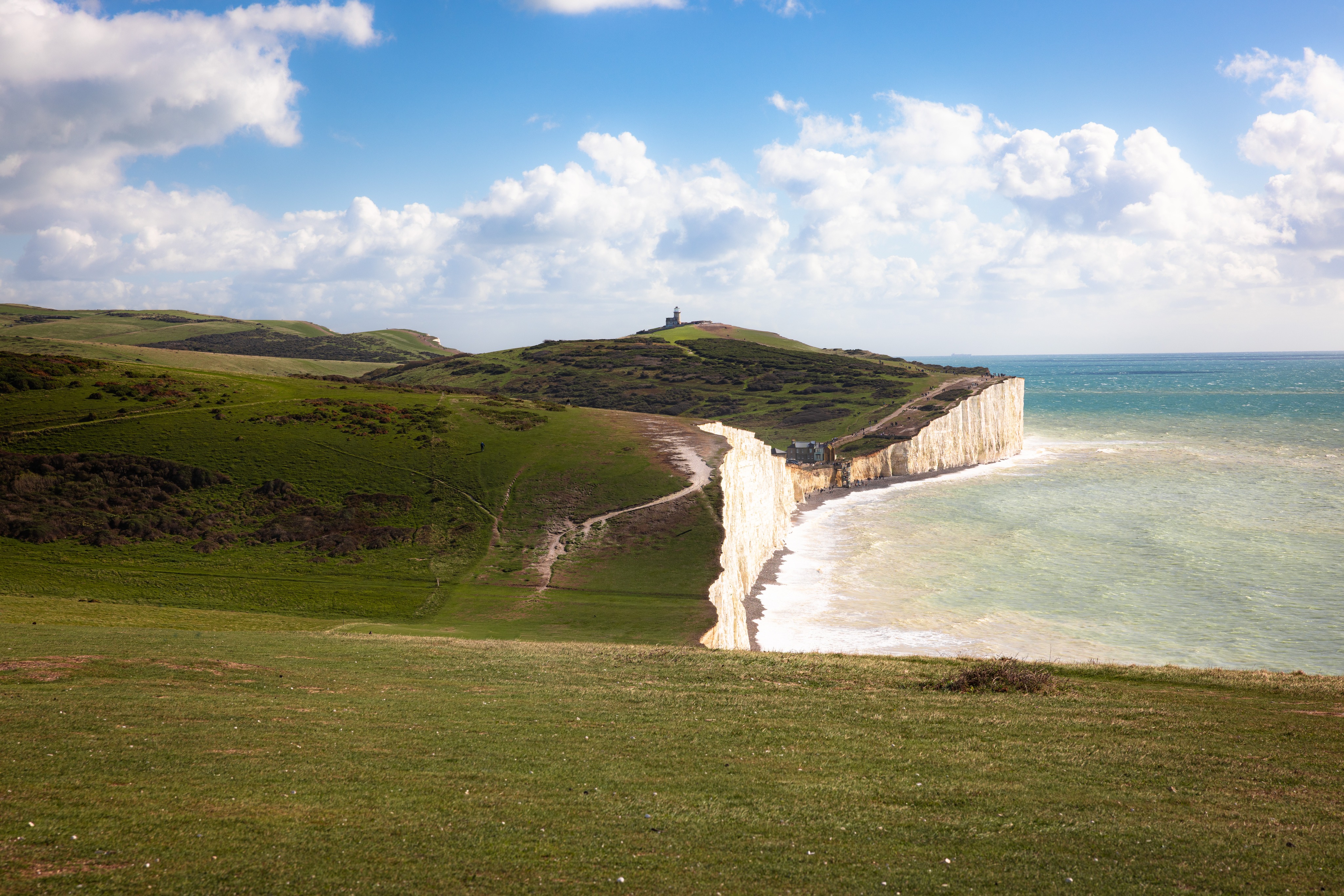 Walking along the Seven Sisters with Belle Tout Lighthouse in the distance.